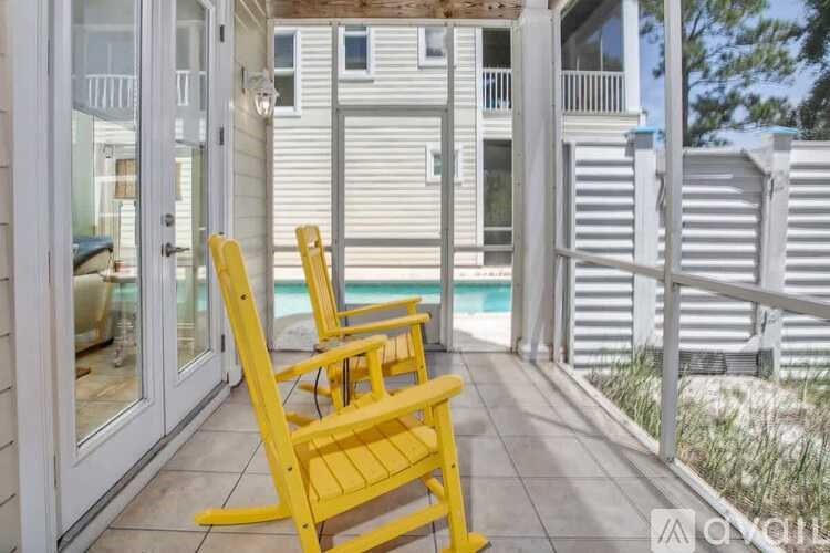 Two yellow chairs are placed on a patio.