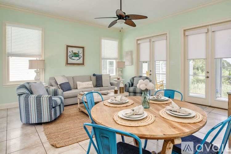 A dining room with a round table set for four.
