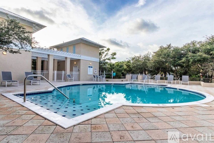 A pool in front of a house with the word "available" written on the bottom right.