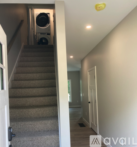 A staircase with a washing machine in the bottom left corner.