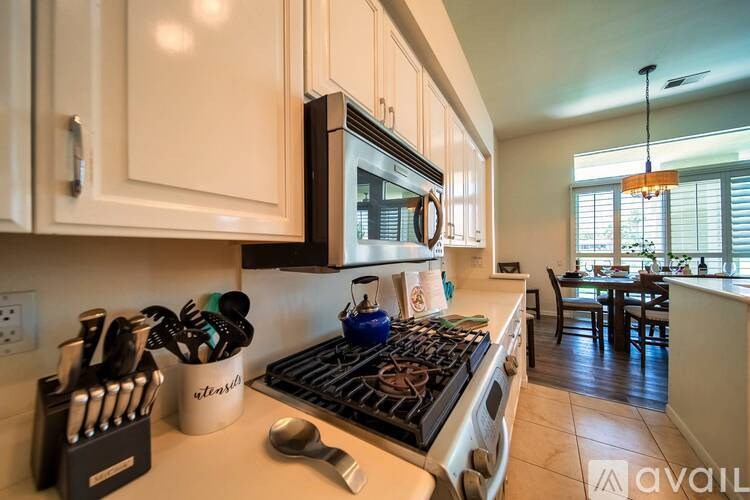A kitchen with a stove top oven and a microwave above it.