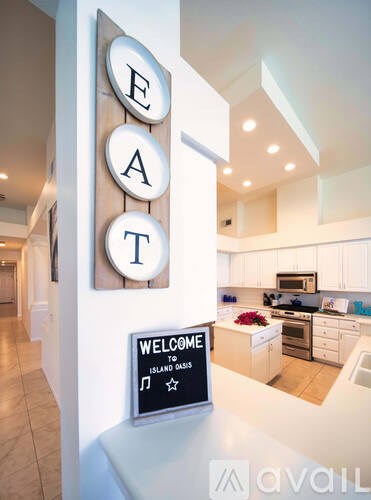 A kitchen with a sign that says "Welcome to Island Dads".