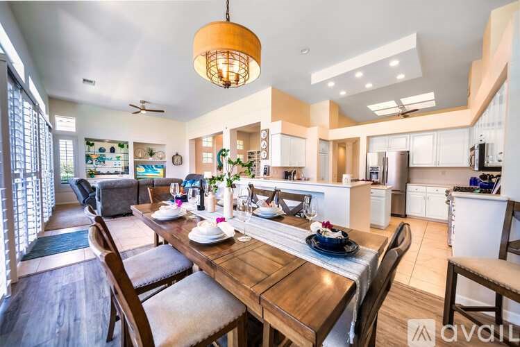 A well-lit dining area with a wooden table and chairs.