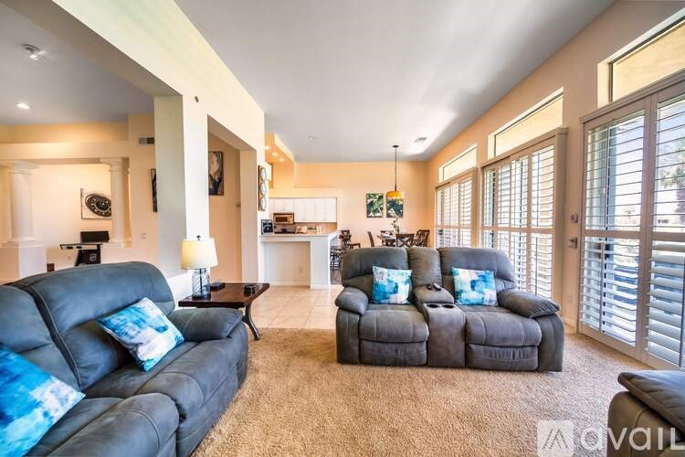 A living room with a black couch and a coffee table.