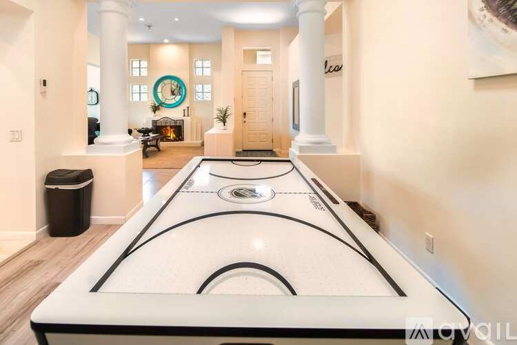 A pool table is in the middle of a room with a white background.