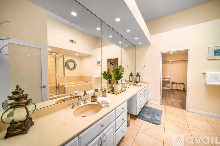 A bathroom with a double sink vanity and a large mirror.