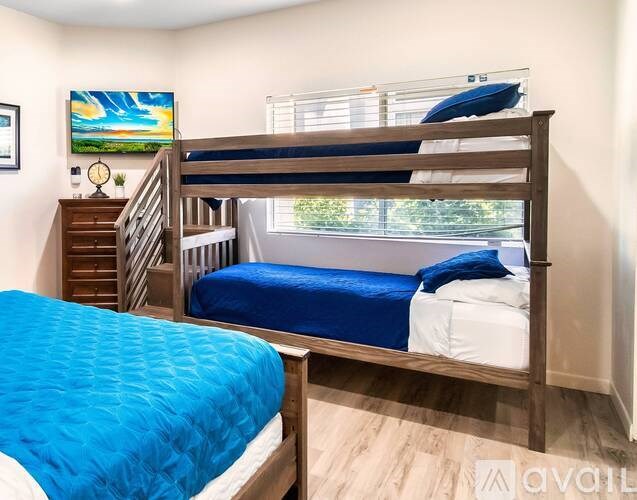 A bedroom with a bunk bed and a single bed.