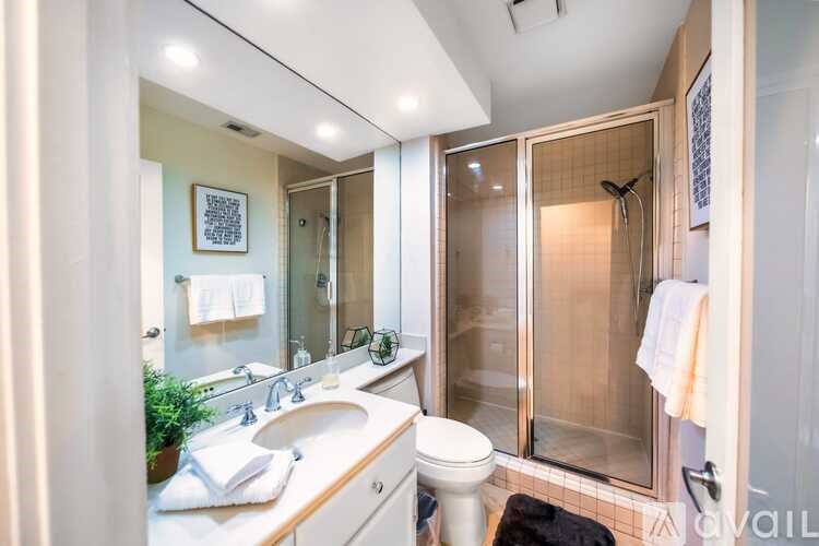 A bathroom with a sink, toilet, and shower.