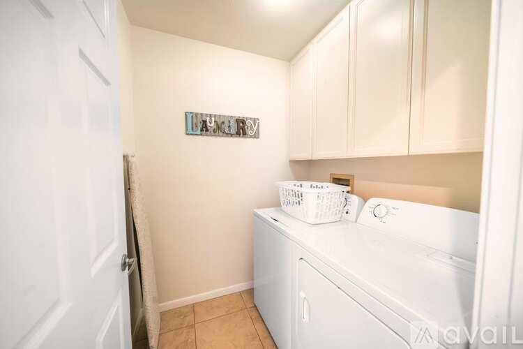 Laundry sign on a wall above a washing machine.