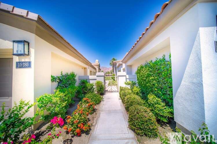 A row of houses with a pathway in the middle.
