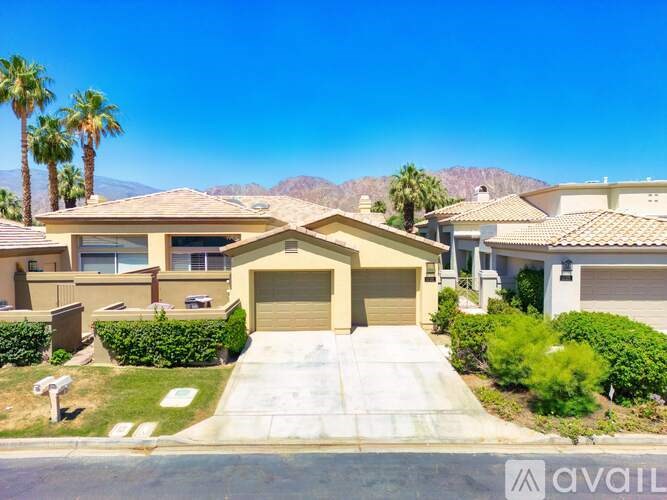 A house with a brown roof and a garage door is for sale.