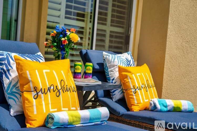 A sunny day outdoor setting with cushions and pillows.