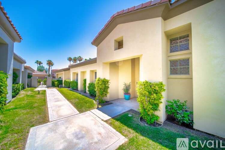 A row of houses with a pathway in the middle.