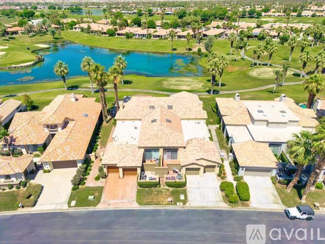 A bird's eye view of a neighborhood with a large house in the center.