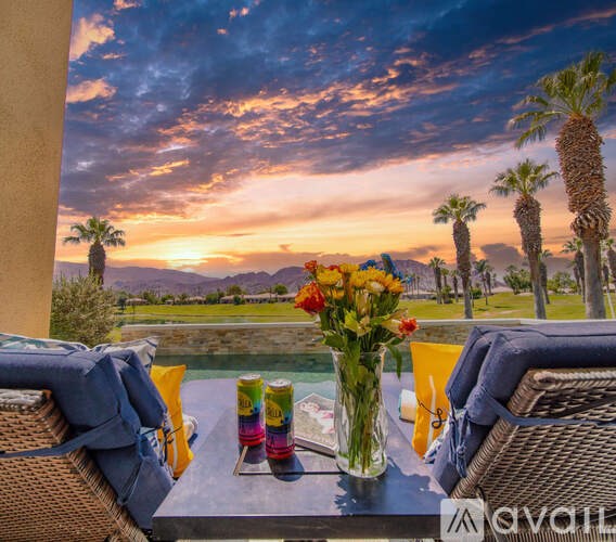 A table with a vase of flowers and cans on it.