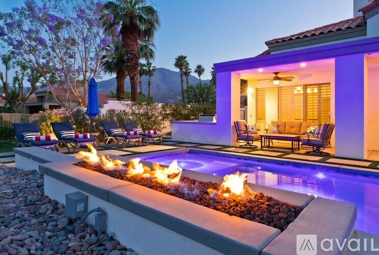A house with a pool and a fire pit in the backyard.