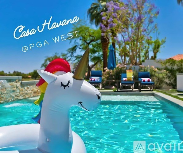 A pool with a unicorn float in it.