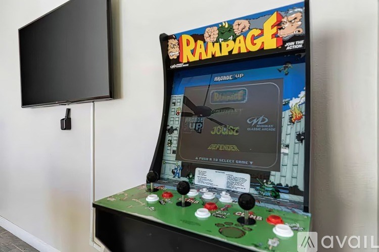 A small arcade game machine called Rampage sits on a table.