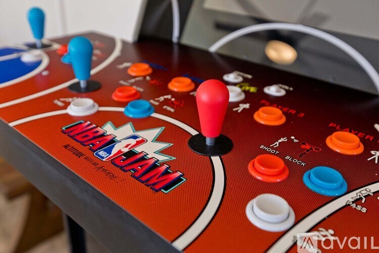 A red arcade game with a red joystick in the middle.