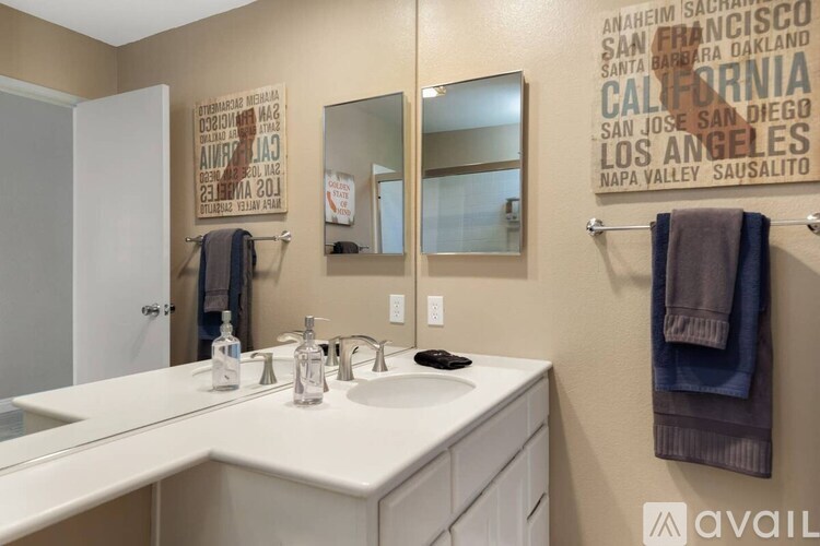 A bathroom with a white sink and a mirror.