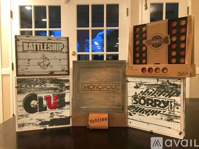 A collection of wooden boxes with different designs including Monopoly and Sorry.