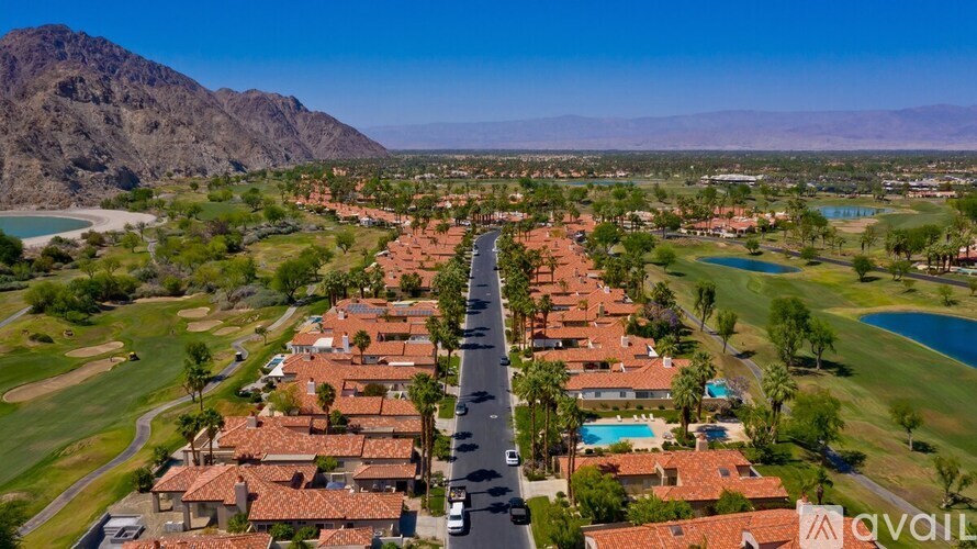 A bird's eye view of a residential area with a road running through it.