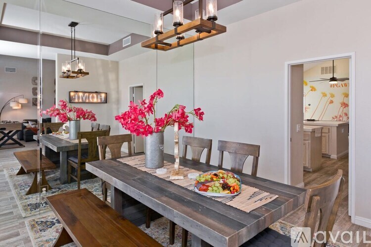 A dining room with a wooden table and chairs.