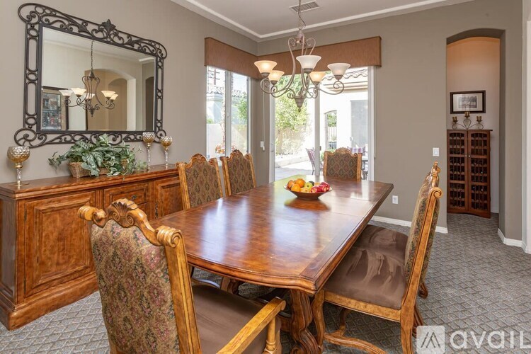A dining room with a wooden table and chairs.