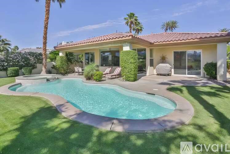 A house with a pool in the backyard.