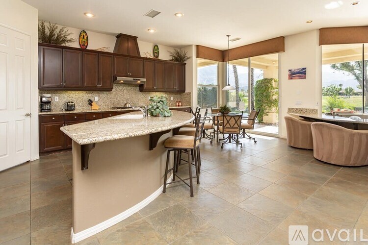 A kitchen with a bar area and a dining table.