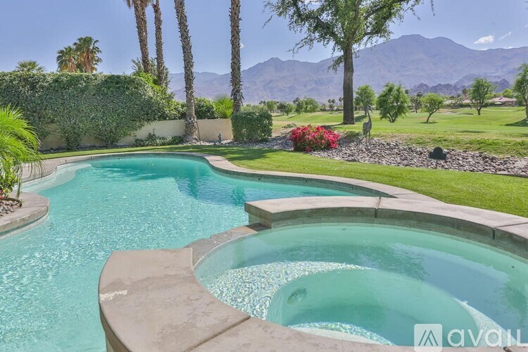 A pool with a waterfall in the middle of it.