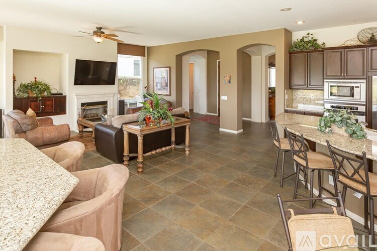 A living room with a couch, a coffee table, and a television.