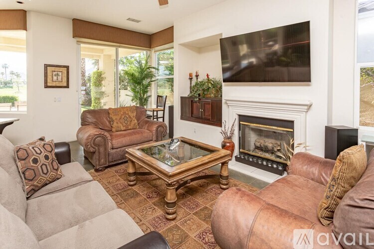 A living room with a fireplace and a television.