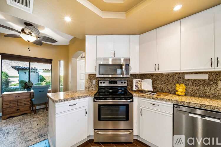 A kitchen with a stove top oven and a dishwasher.