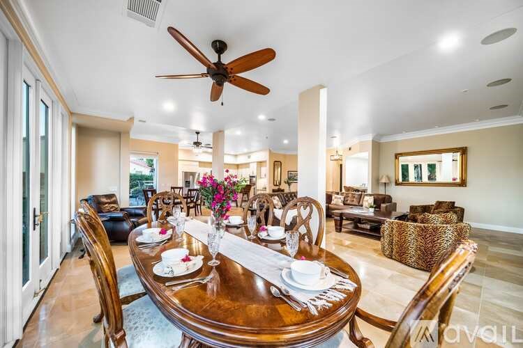 A dining room with a wooden table set for a meal.