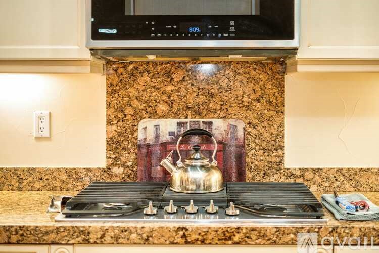 A stove top with a kettle on it.
