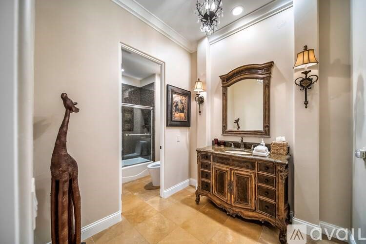 A bathroom with a wooden vanity and a large mirror.