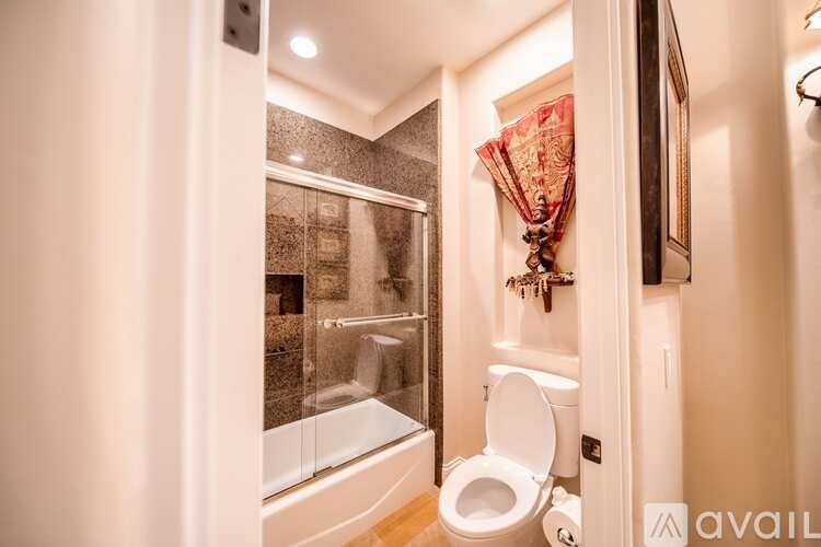 A bathroom with a toilet, a bathtub, and a shower.