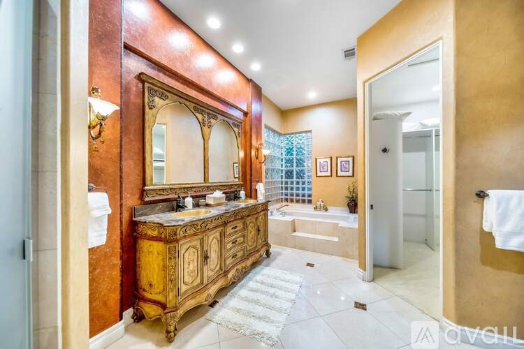 A bathroom with a large vanity and a bathtub.