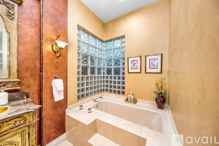 A bathroom with a tub and a window.