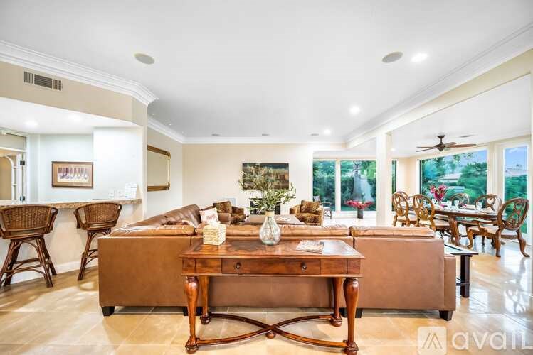 A living room with a brown sofa and a wooden coffee table.