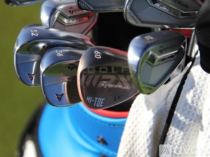 A set of golf clubs with the word "GOLF" visible on the head of the clubs.