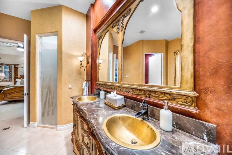 A bathroom with a large mirror and a sink.