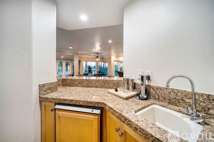 A kitchen with a granite countertop and a sink.
