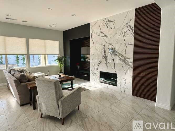 A living room with a fireplace and a chair.