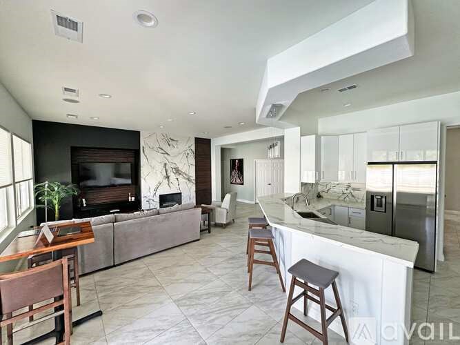 A modern kitchen with a bar stool and a countertop.