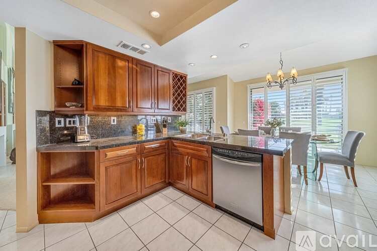 A kitchen with wooden cabinets and a black countertop.