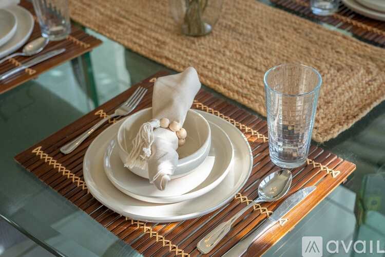 A table setting with a napkin folded into a swan shape.