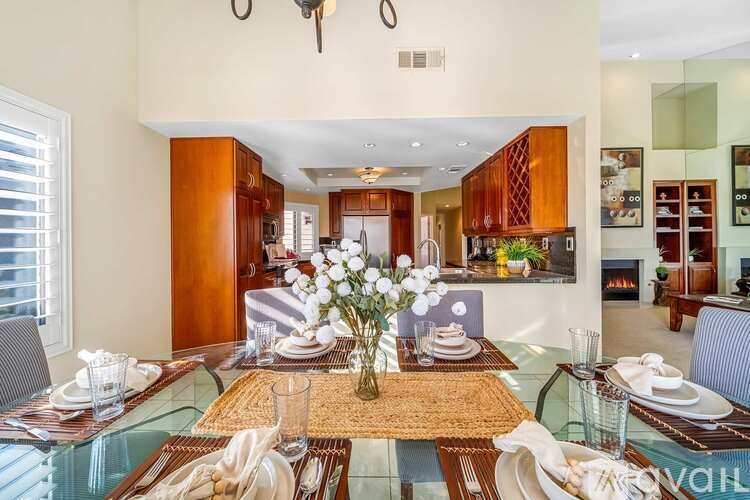 A dining room with a glass table and chairs.