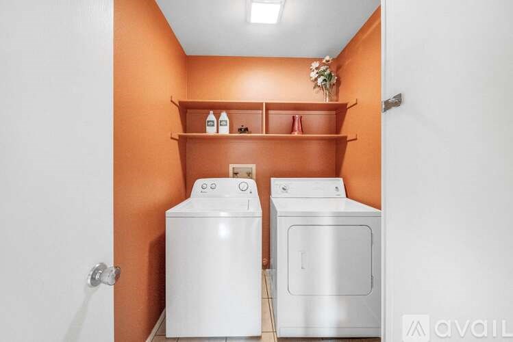 A small laundry room with a washer and dryer.